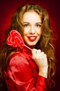 Woman with heart caramel over red background Royalty Free Stock Photo