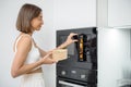 Woman heating food with microwave machine Royalty Free Stock Photo