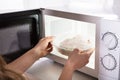 Woman Heating Food In Microwave Oven Royalty Free Stock Photo