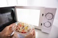 Woman Heating Food In Microwave Oven Royalty Free Stock Photo