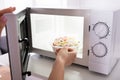 Woman Heating Food In Microwave Oven Royalty Free Stock Photo