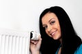 Woman with a heating radiator and thermostat