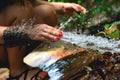 Woman heaving fun with hosepipe splashing water