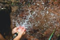 Woman heaving fun with hosepipe splashing water