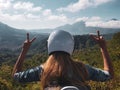 Woman in helmet admire beautiful mountain view in Bali