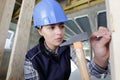 woman with helmet holding hammer in hand Royalty Free Stock Photo