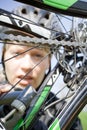 Woman in helmet repairing bicycle