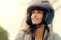Woman, helmet and travel in city for adventure, trip and happy in street for sightseeing. Girl, protection and journey