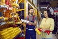 Woman with help of male salesman chooses supplies to repair house in building materials store. Royalty Free Stock Photo