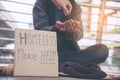 Woman helping hands to homeless people poverty beggar man holding hands asking for money job and hoping help in helpless dirty Royalty Free Stock Photo