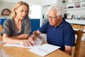 Woman Helping Senior Man To Complete Last Will And Testament At Home Royalty Free Stock Photo