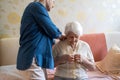 Woman helping senior woman dress Royalty Free Stock Photo