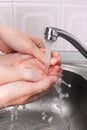 Woman helps child to wash his hands Royalty Free Stock Photo