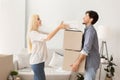 Woman Helps Husband Pack And Carry Boxes Before Moving Apartment