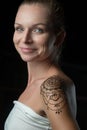 Woman with henna tattoo on her shoulder