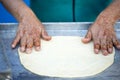 Woman with henna tattoos on hands preparing pancakes. Msemen Round flatbread dough prepared on the grill, Marrakech, Morocco Essa Royalty Free Stock Photo