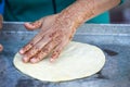 Woman with henna tattoos on hands preparing pancakes. Msemen Round flatbread dough prepared on the grill, Marrakech, Morocco Essa Royalty Free Stock Photo