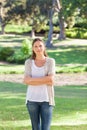 Woman with her arms folded standing in the park Royalty Free Stock Photo