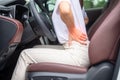 Woman with her back sprain while driving car long time, back body ache due to Piriformis Syndrome, Low Back Pain and Spinal Royalty Free Stock Photo