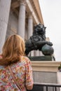 Woman with her back turned in front of the statue of lions in the Congress of Deputies in Madrid, Spain Royalty Free Stock Photo