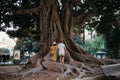 Woman with her boyfriend go to an old Valencian Ficus Macrophylla tree in Spain Royalty Free Stock Photo