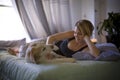 Woman with her dog in the bed at home