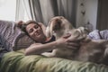 Woman with her dog in the bed at home