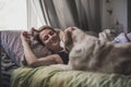 Woman with her dog in the bed at home