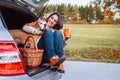 Woman with her dog have a tea time during their autumn auto travel Royalty Free Stock Photo