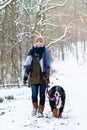 Woman with her dog hiking or walking in winter Royalty Free Stock Photo