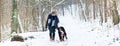 Woman with her dog hiking or walking in winter Royalty Free Stock Photo