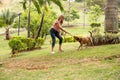 Woman with her dog in the park, playing with the leash