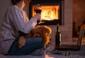 Woman with her dog sits at the floor and drinking wine Royalty Free Stock Photo