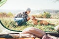 Woman and her dog tender scene near the camping tent. Active leisure, traveling with pet6 simple things concept image