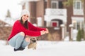 Woman with her dog on a walk outside on a winter day