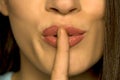 Woman with her finger on her lips Royalty Free Stock Photo