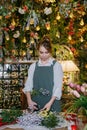 A woman in her florist shop collects bouquets of flowers. The concept of a small business. Bouquets of tulips for the Royalty Free Stock Photo