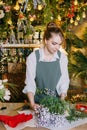 A woman in her florist shop collects bouquets of flowers. The concept of a small business. Bouquets of tulips for the Royalty Free Stock Photo