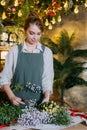 A woman in her florist shop collects bouquets of flowers. The concept of a small business. Bouquets of tulips for the Royalty Free Stock Photo