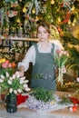 A woman in her florist shop collects bouquets of flowers. The concept of a small business. Bouquets of tulips for the Royalty Free Stock Photo