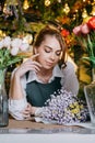 A woman in her florist shop collects bouquets of flowers. The concept of a small business. Bouquets of tulips for the Royalty Free Stock Photo