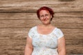 woman in her forties against a wood stained background Royalty Free Stock Photo