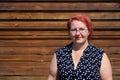 woman in her forties against a wood stained background Royalty Free Stock Photo