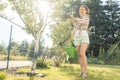 Woman in her garden watering fruit tree Royalty Free Stock Photo