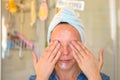 Woman applying moisturiser or cleansing cream Royalty Free Stock Photo