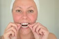 Woman fitting a mouth guard to protect her teeth