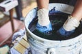 A woman soaking fabric in indigo dye