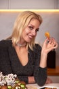 A woman with her hands eats a large appetizing shrimp. Selective focus.