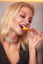 A woman with her hands eats a large appetizing shrimp. Selective focus.