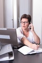 Woman in her homeoffice on the phone